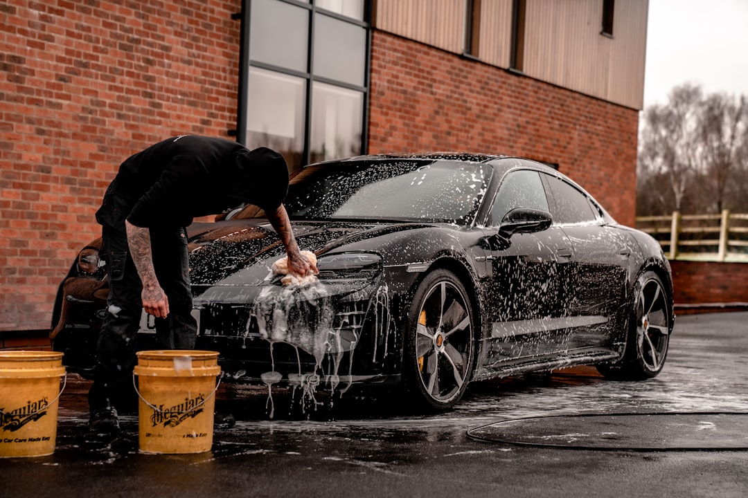 about-02 man-in-black-t-shirt-and-black-pants-doing-water-splash-on-black-coupe-during-daytime-ep8h7yvhfhk