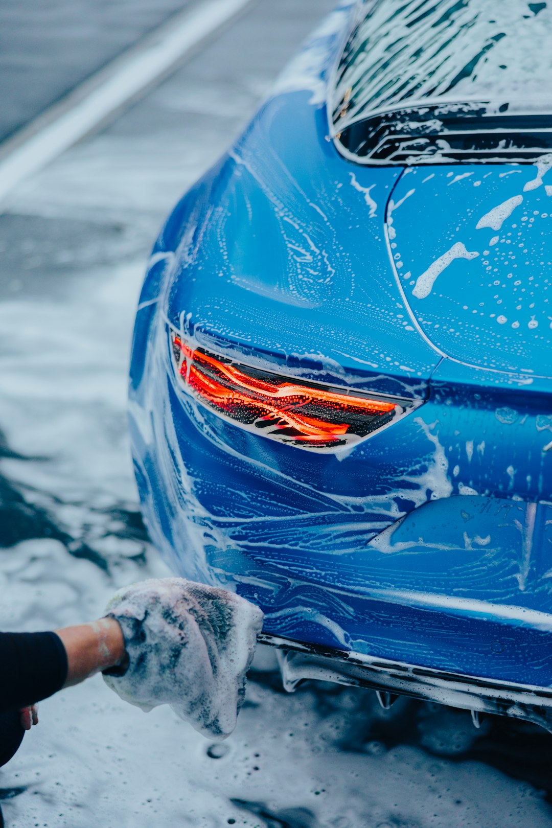 about-01 a-person-washing-a-blue-car-with-a-rag-a9nu9-pvjiw